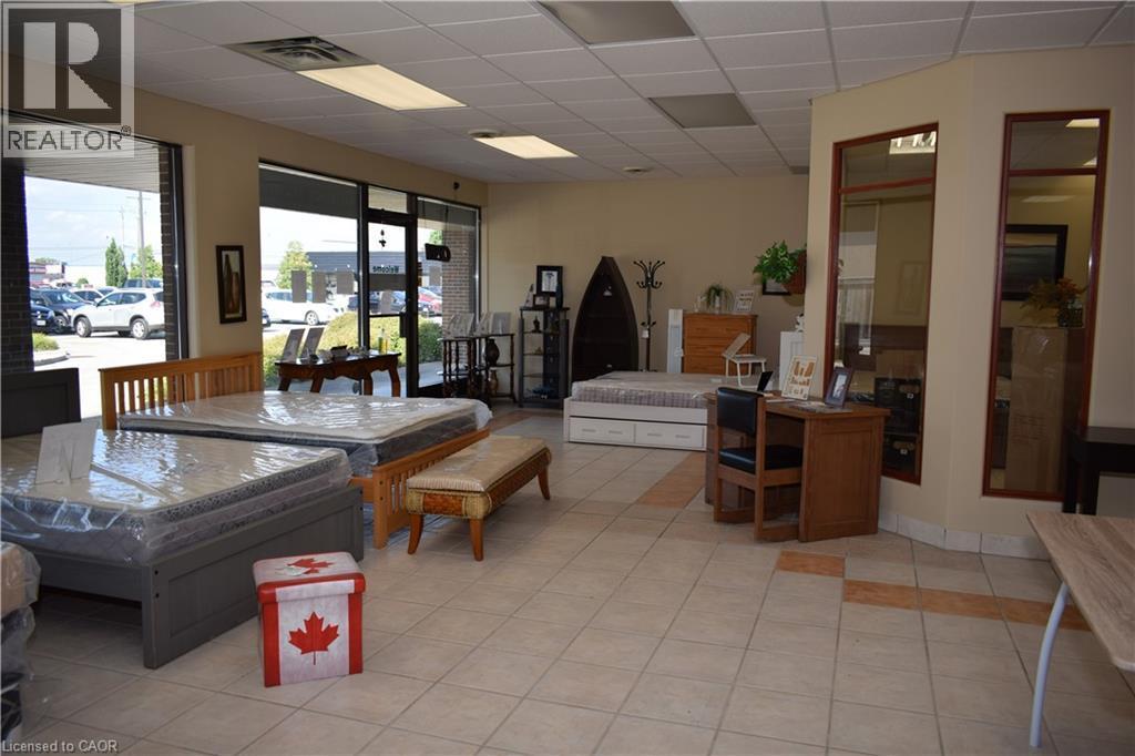 Living area with a paneled ceiling and light tile patterned flooring - 1151 Victoria Street N Unit# 8, Kitchener, ON