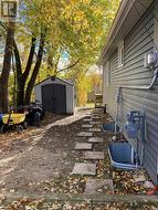 pathway to back deck and yard with vinyl shed -