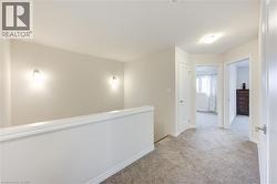 Corridor featuring carpet floors and baseboards -