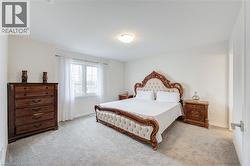 Bedroom featuring light carpet and baseboards -