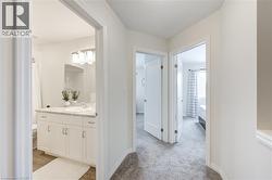 Hall with light colored carpet -