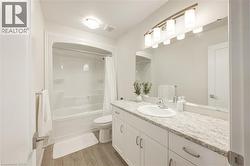 Full bathroom featuring shower / bath combo, light wood-style flooring, and vanity -