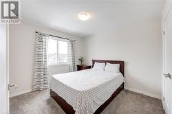 Bedroom with carpet flooring and baseboards -