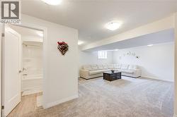 Living room with a textured ceiling and light colored carpet -