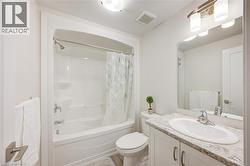 Full bathroom with shower / bathtub combination with curtain and vanity -