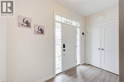 Entrance foyer featuring light wood-style flooring and baseboards -