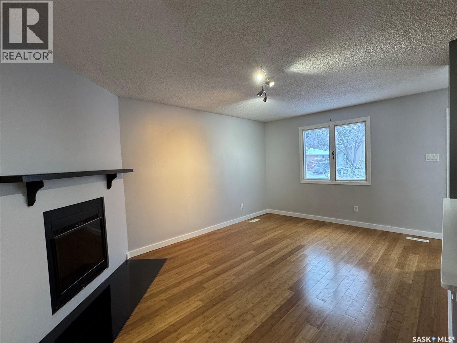 138 Thomson Avenue, Regina, SK - Indoor Photo Showing Other Room With Fireplace