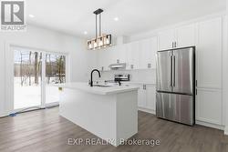 Kitchen featuring quartz countertops and backsplsh -