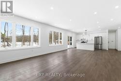 View from living room to kitchen, wall of windows -
