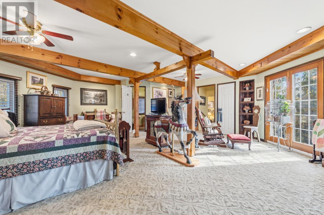 Octagon Shaped Primary Suite With Walkout to Deck - 74 Cottage Lane, Tweed (Elzevir (Twp)), ON - Indoor Photo Showing Bedroom