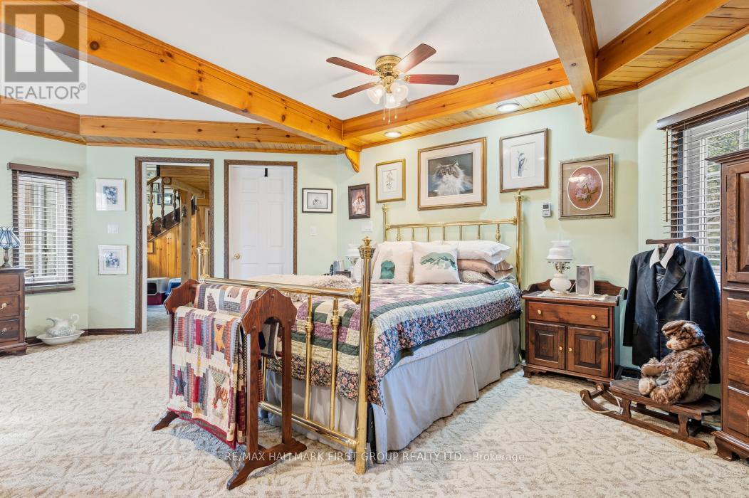 Primary Suite With Walkout to Deck & 5 PC Bath - 74 Cottage Lane, Tweed (Elzevir (Twp)), ON - Indoor Photo Showing Bedroom