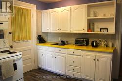 Kitchen with back door to back porch area & yard -