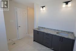 tiled shower & double sink vanity in ensuite bath -