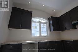 Cathedral ceiling w/potlights over sink window -