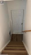 Stairway featuring wood finished floors and baseboards -
