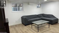 Living area with light wood-style flooring and recessed lighting -