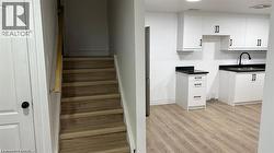 Stairs with wood finished floors and baseboards -