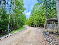 With rock lined private windingdriveway. -