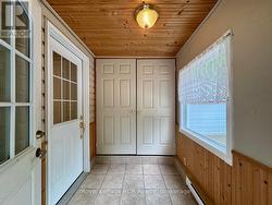 Enter the large mudroom with double door storage. -