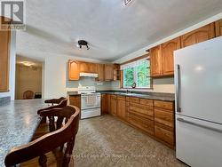 Enter the large wood cabinetry kitchen. -