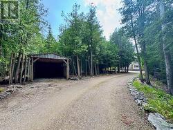 Separate carport near the entranceof the driveway -