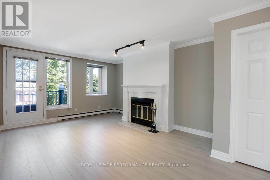 Living Room with Wood Burning Fireplace - 304 - 100 Bruyere Street, Ottawa, ON - Indoor With Fireplace