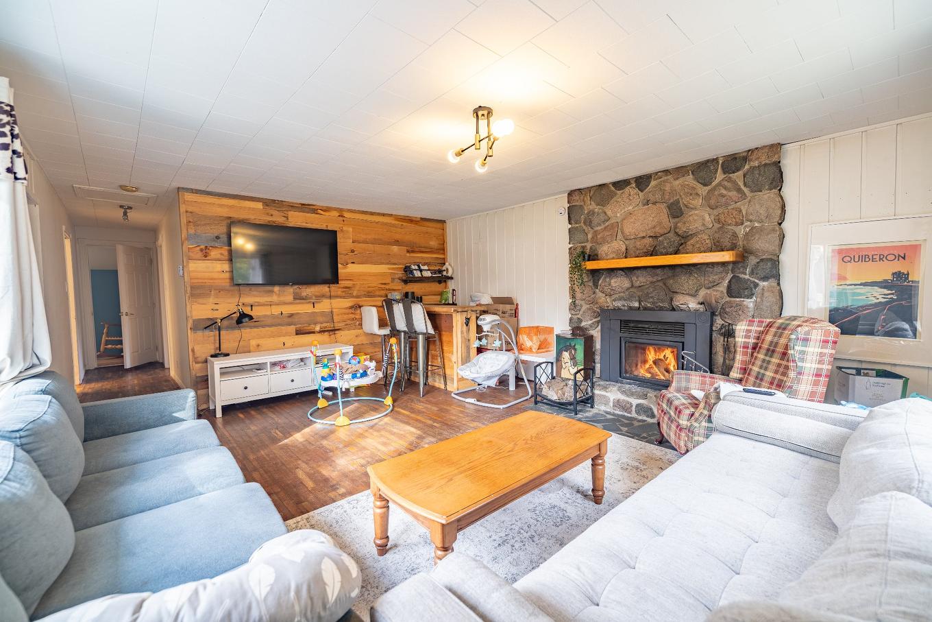 Aerial photo - 194 Ch. Du Ruisseau, Lac-Supérieur, QC - Indoor Photo Showing Living Room With Fireplace