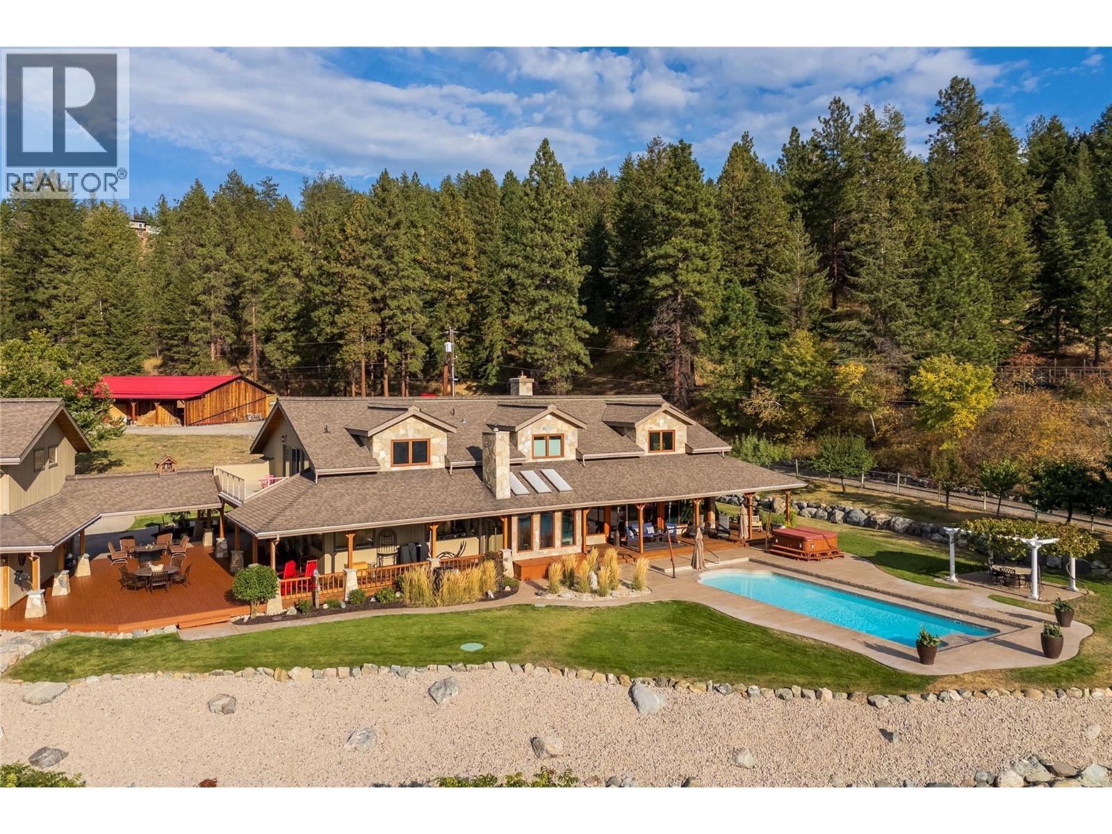 Overview of the House and Pool with Barn in the background - 5705 Upper Booth N Road, Kelowna, BC - Outdoor With In Ground Pool With Deck Patio Veranda