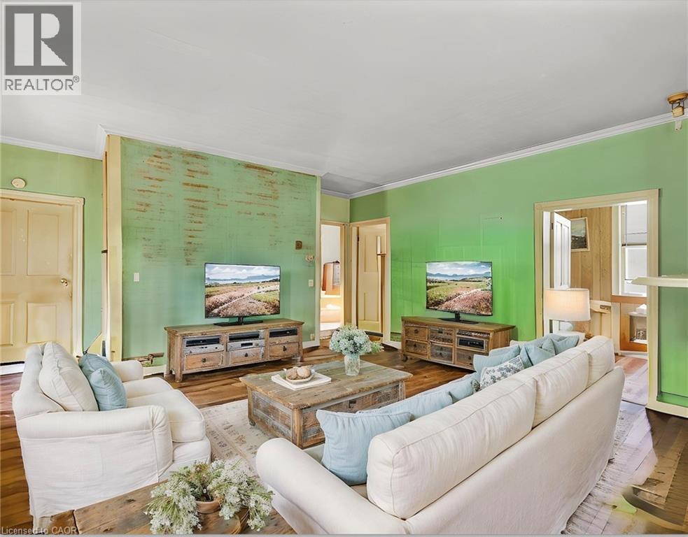 Living area with crown molding and wood finished floors Virtual Staged - 36 Elgin E/S Street W, Conestogo, ON - Indoor Photo Showing Living Room