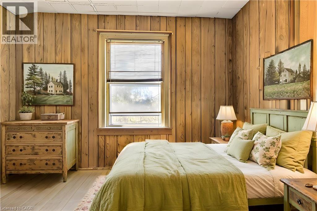 Bedroom featuring wooden walls and wood finished floors Virtual Staged - 36 Elgin E/S Street W, Conestogo, ON - Indoor Photo Showing Bedroom