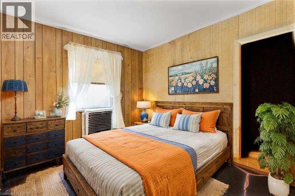 Bedroom with cooling unit and wood walls Virtual Staged - 36 Elgin E/S Street W, Conestogo, ON - Indoor Photo Showing Bedroom