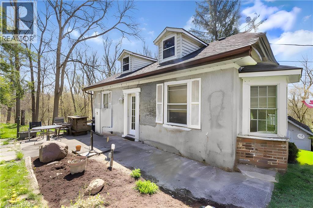 View of side of property featuring a patio, roof with shingles, and stucco siding - 36 Elgin E/S Street W, Conestogo, ON - Outdoor