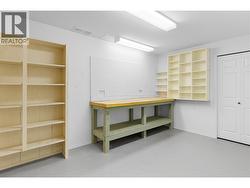 BASEMENT WORKSHOP - Workbench and shelving, storage. -