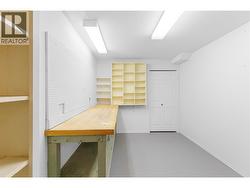 BASEMENT WORKSHOP - Workbench and shelving, storage. -
