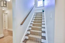 Stairs to the bright lower level. -