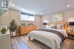 Virtually staged lower level bedroom. -