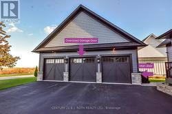 3 car garage with oversize middle door & man door. -