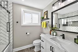 4-Piece Bathroom with Herringbone Tile in Shower. -