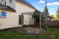 Side patio and pergola by sliding door -