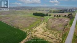 Aerial view from east before corn planted. -