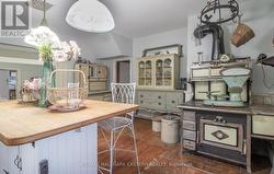 Kitchen. Door to Foyer, behind stairway, centre. -