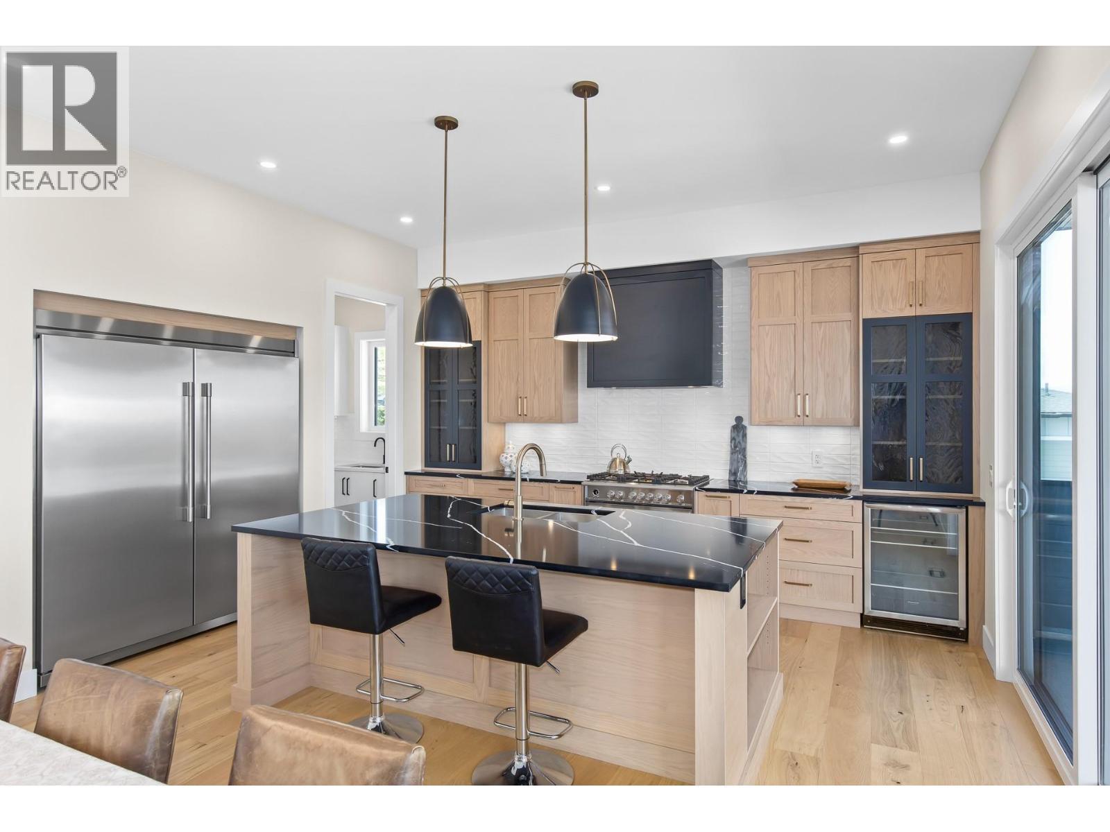 Designer kitchen with large island. - 4964 Bucktail Lane, Kelowna, BC - Indoor Photo Showing Kitchen With Upgraded Kitchen