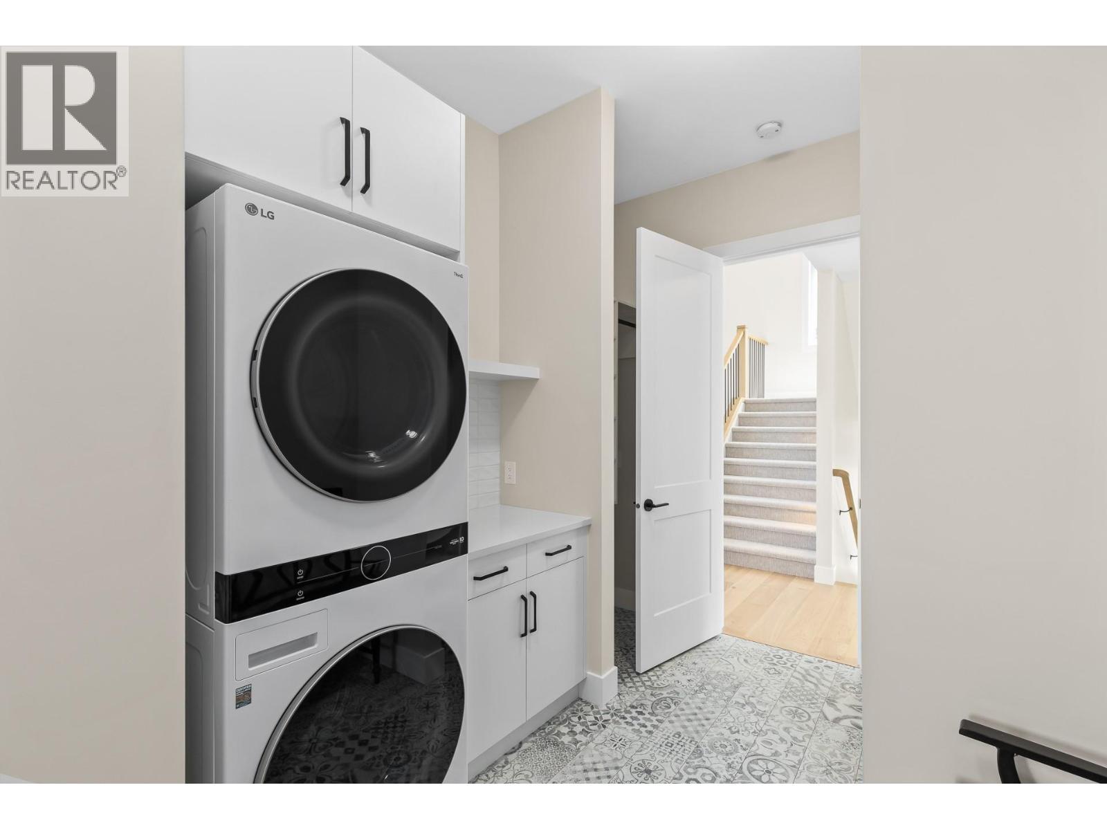 Laundry/mud room that leads into pantry. - 4964 Bucktail Lane, Kelowna, BC - Indoor Photo Showing Laundry Room