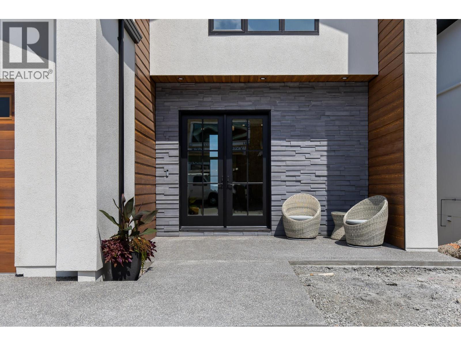 Exterior front entry with stone, wood and stucco. - 4964 Bucktail Lane, Kelowna, BC - Outdoor