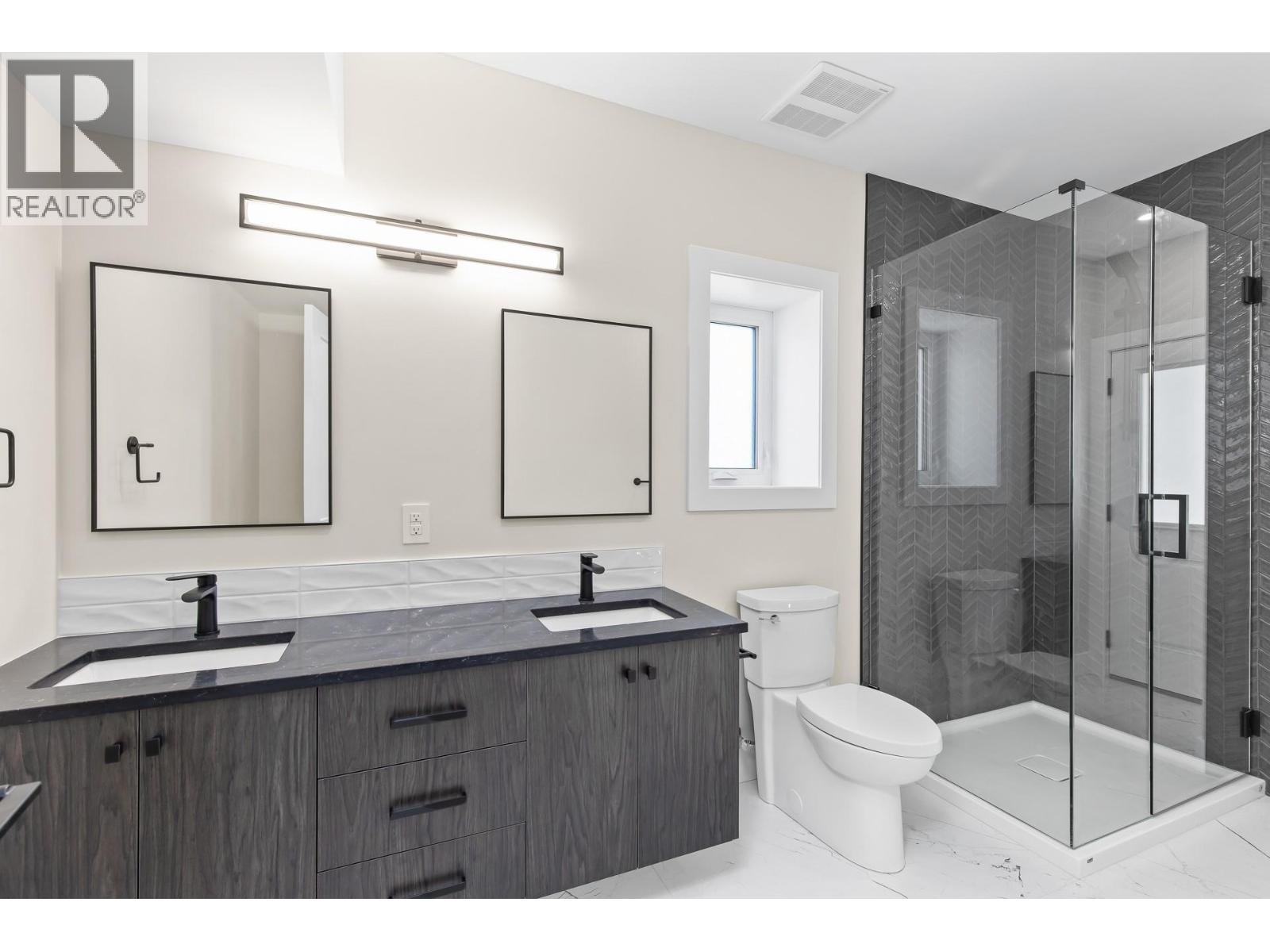 Lower level washroom with double vanity - 4964 Bucktail Lane, Kelowna, BC - Indoor Photo Showing Bathroom