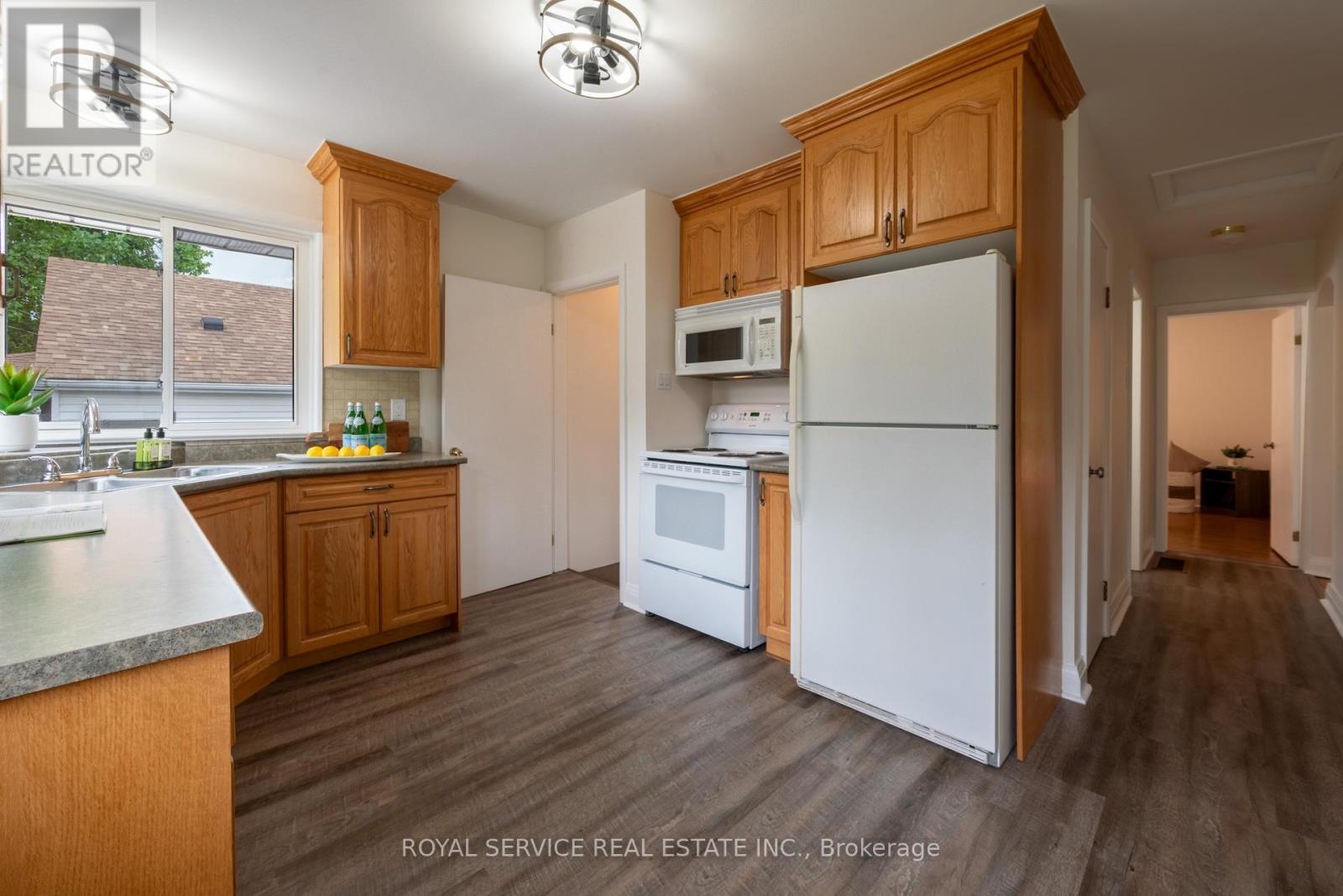 Kitchen w stairs to basement & side door - 24 Division Street, Cramahe (Colborne), ON - Indoor Photo Showing Kitchen With Double Sink