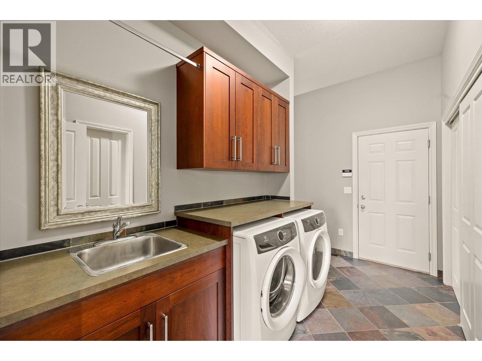 Laundry Room, Garage Entrance and stairs to downstairs. - 10726 Nighthawk Road Unit# 60, Lake Country, BC - Indoor Photo Showing Laundry Room