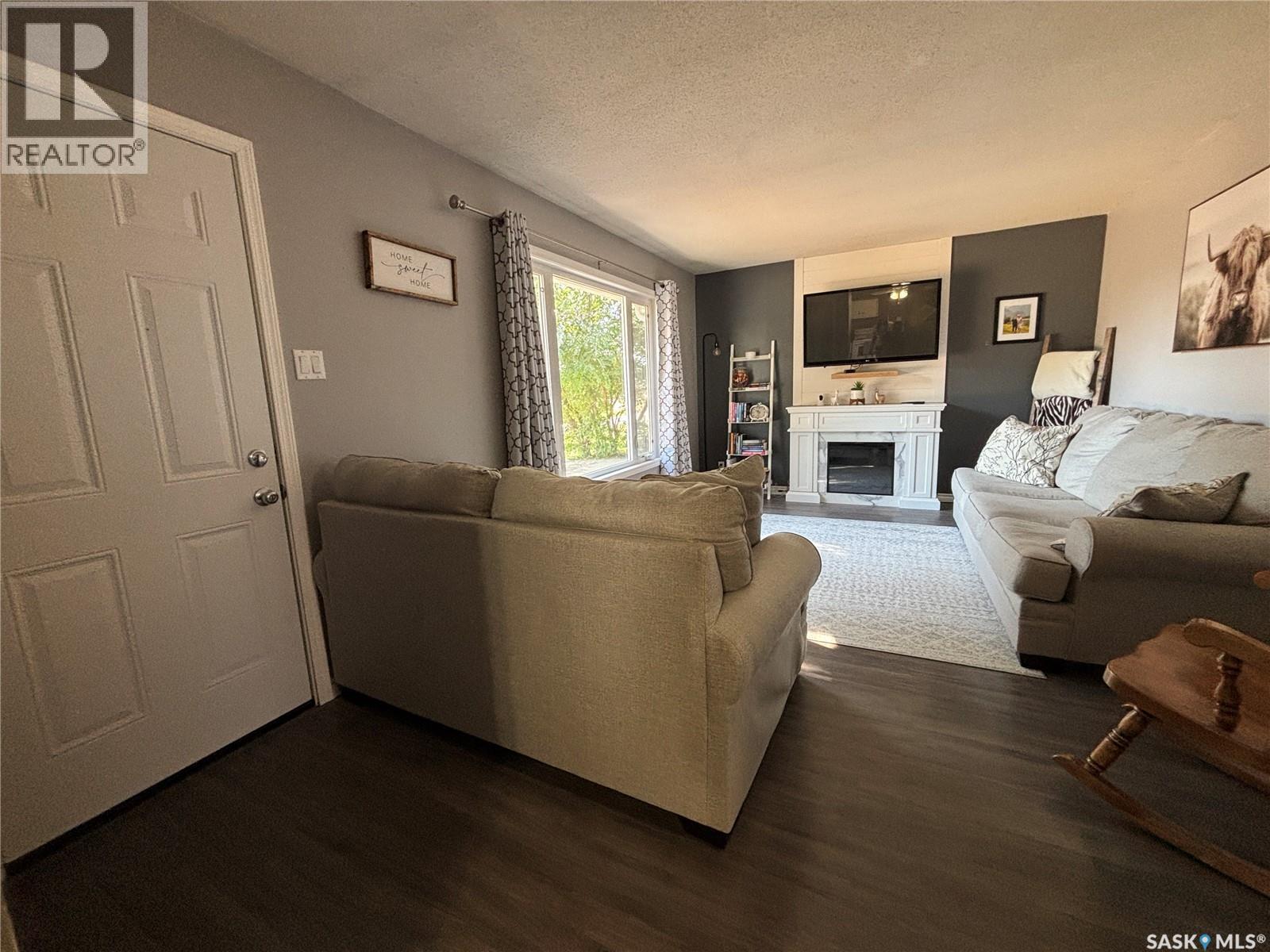 213 Griffin Street, Maple Creek, SK - Indoor Photo Showing Living Room With Fireplace