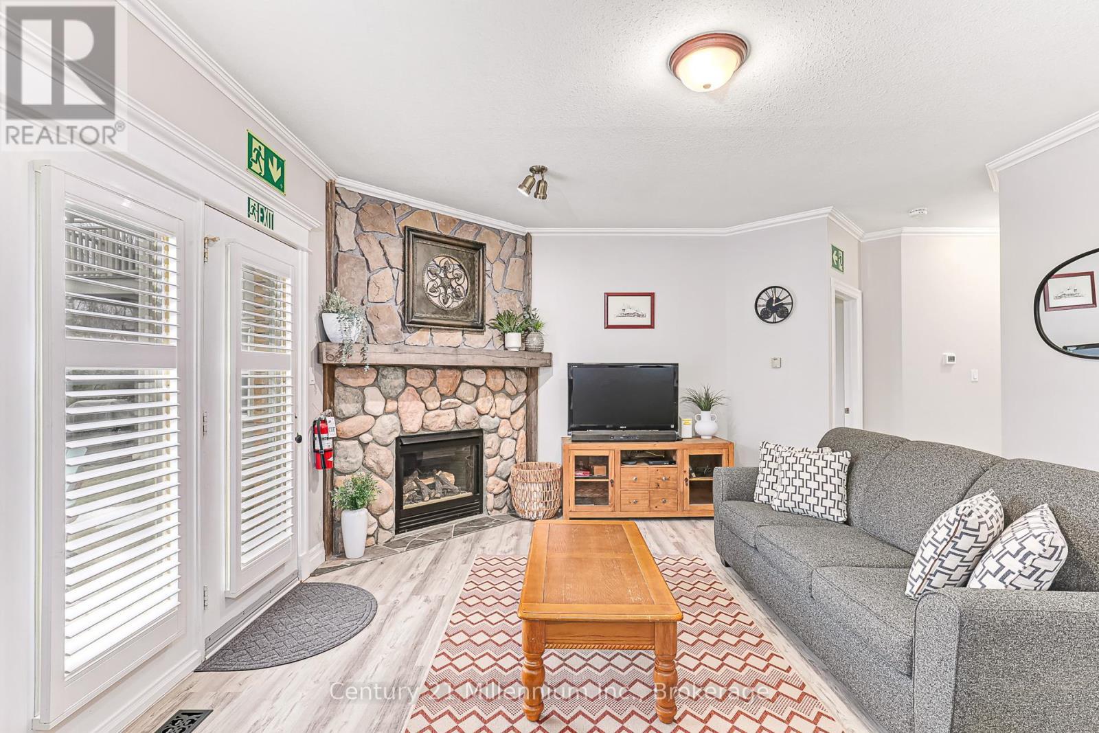 120 - 184 Snowbridge Way, Blue Mountains, ON - Indoor Photo Showing Living Room With Fireplace