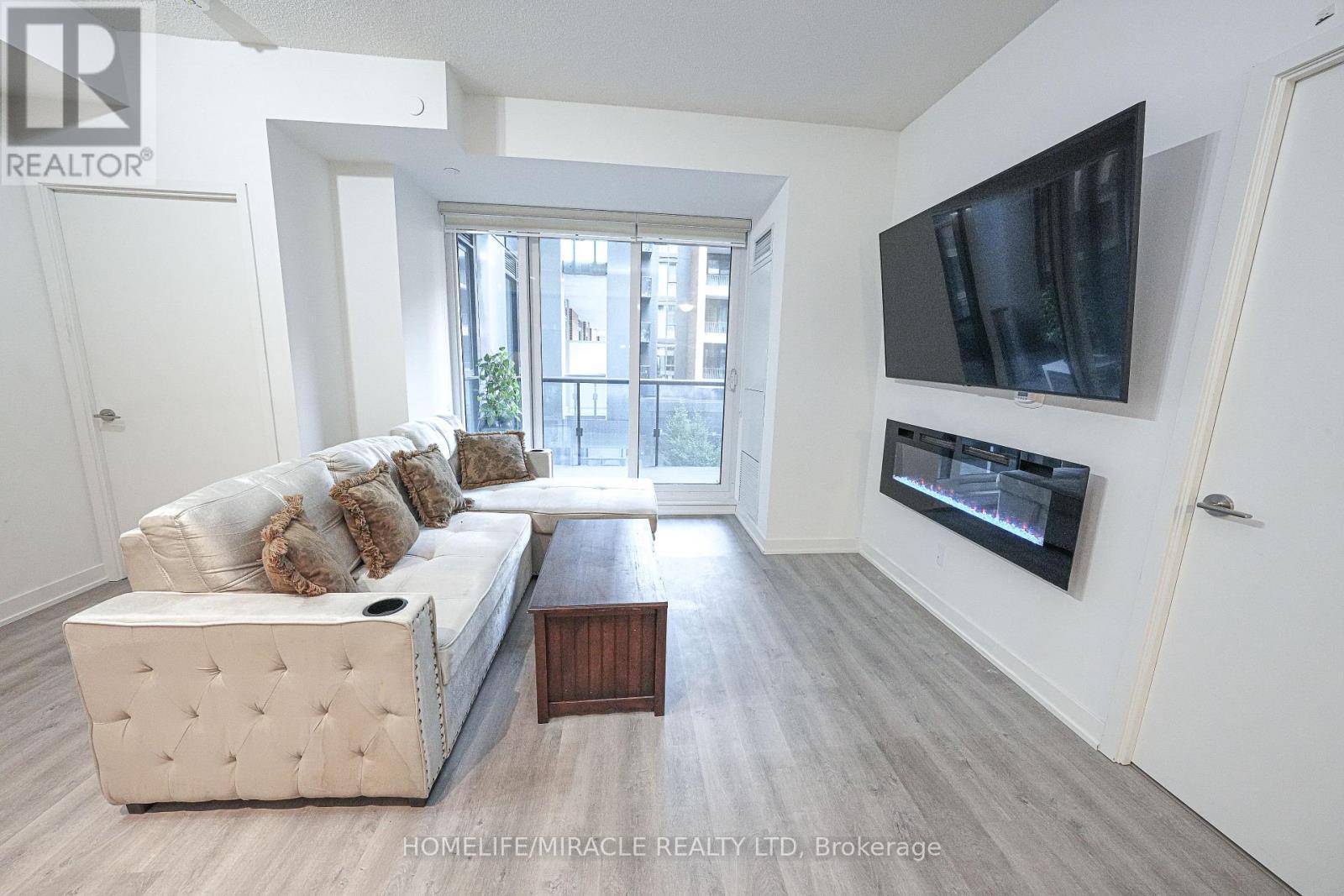 705 - 8119 Birchmount Road, Markham, ON - Indoor Photo Showing Living Room With Fireplace